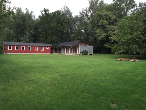 Große Lager-Spielwiese mit Blick vom Lärmschutzdamm zum Heim